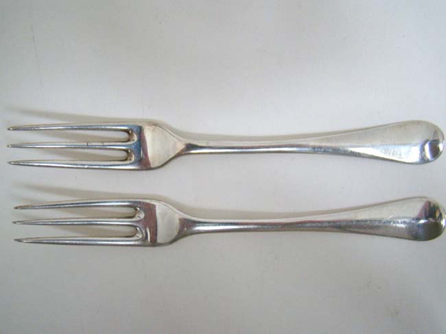 A pair of English sterling silver three prong Dessert Forks, maker S I or I S, London 1736